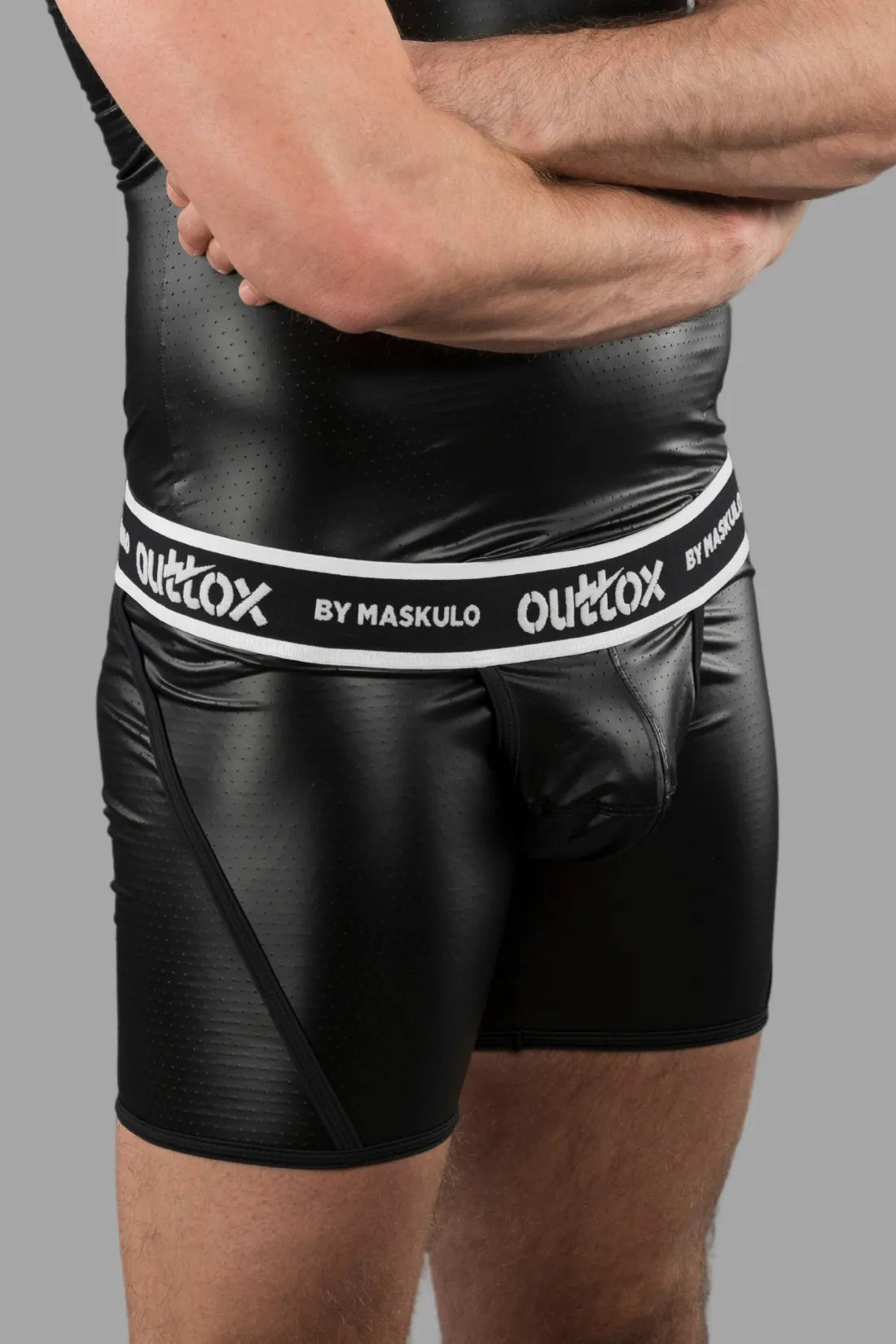 Outtox by Maskulo black shorts with snap codpiece and wrapped rear. Polyester, PU eco leather, and elastane blend for comfort and style.